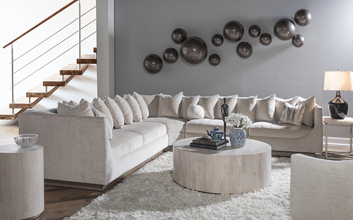 Artistica Upholstery scene featuring a sectional, two side tables, a cocktail table and a chair.