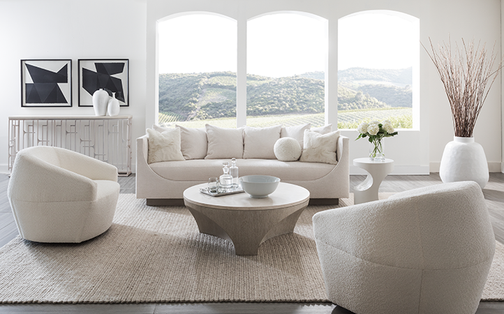 Artistica Upholstery scene featuring a sofa, one side tables, a console, a cocktail table and two chairs.