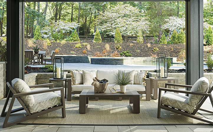 Mozambique living room scene featuring sofa, two chairs, a cocktail table and end tables.