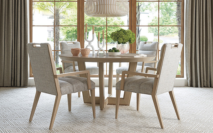 Sunset Key dining room scene featuring dining table with side and arm chairs.