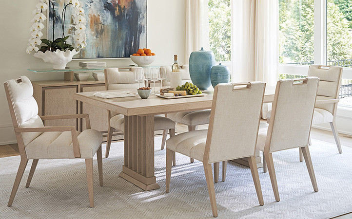 Sunset Key dining room scene featuring dining table with side and arm chairs.