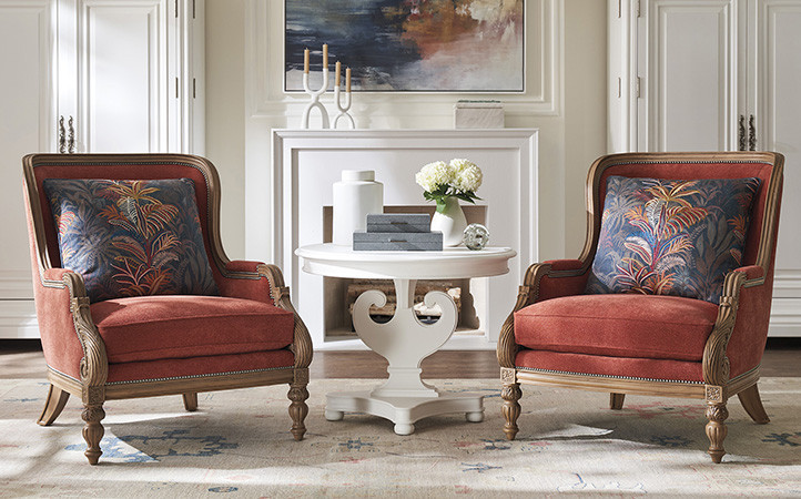 Villa Blanca living room scene featuring two red upholstered chairs.